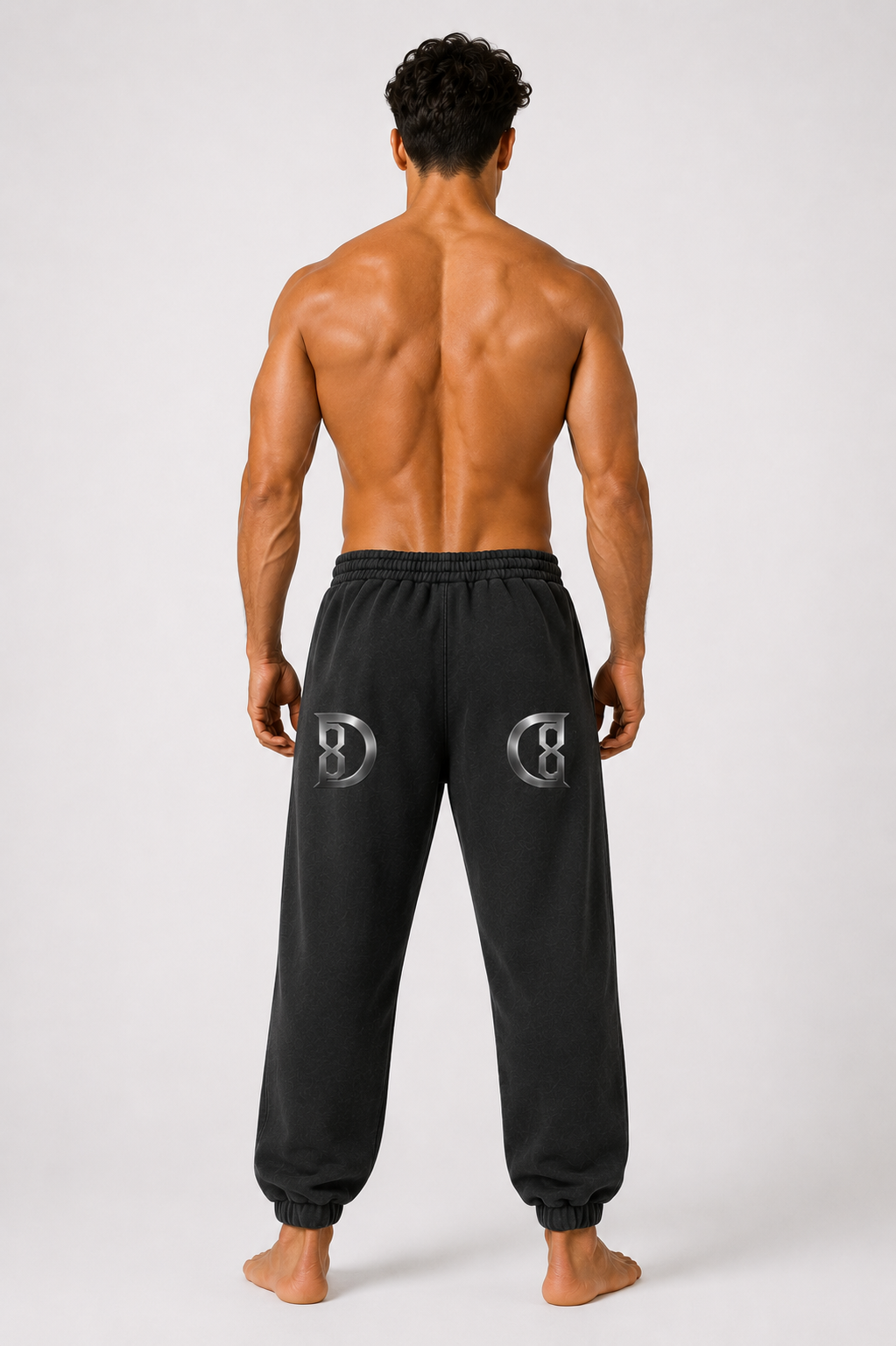 Model wearing the black DOMIN8NY Lion fleece sweatpants, alternate side view