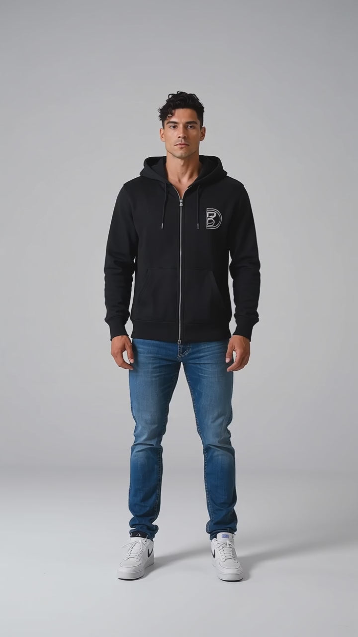Model wearing the black DOMIN8NY Lion zip-up hoodie, front view