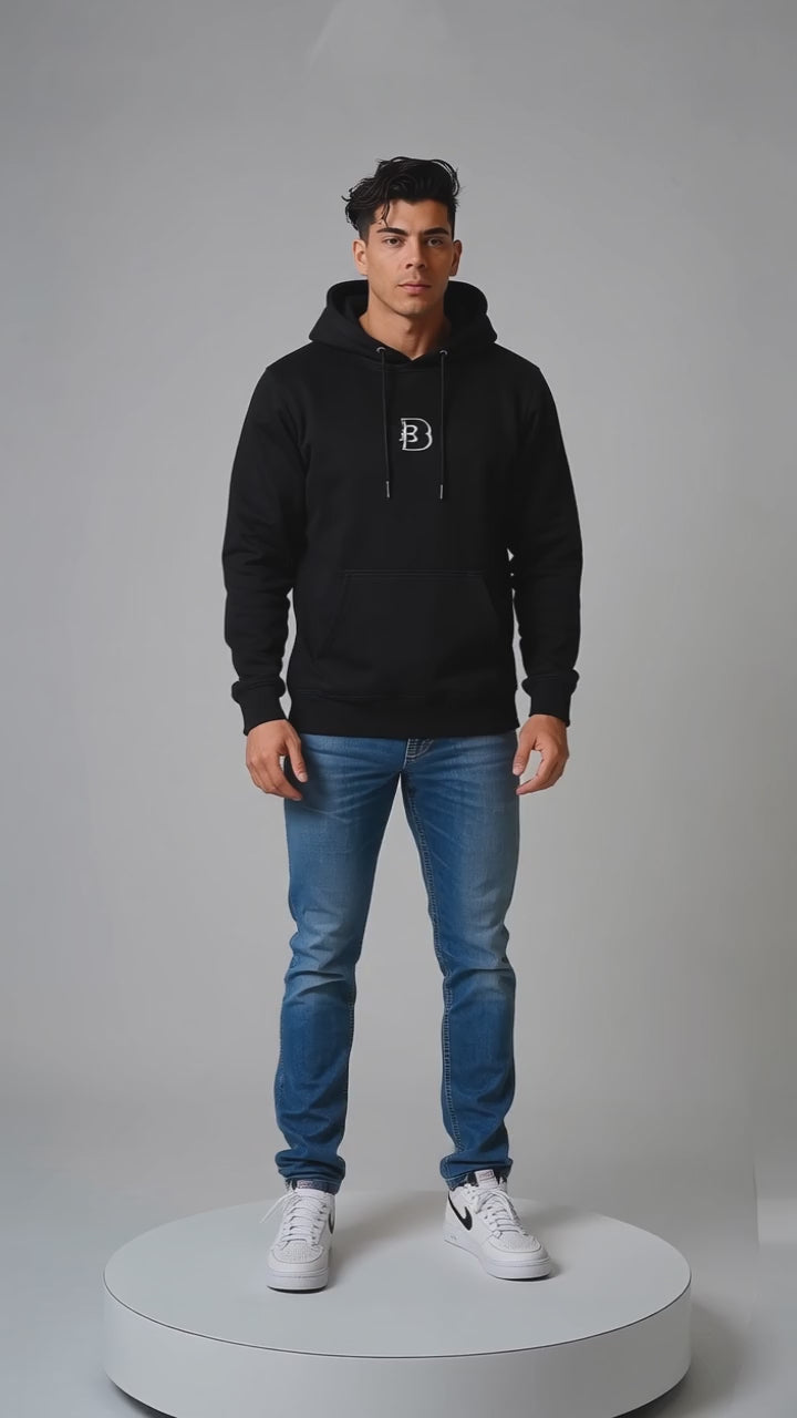 Model wearing the black DOMIN8NY Crown fleece hoodie, front view