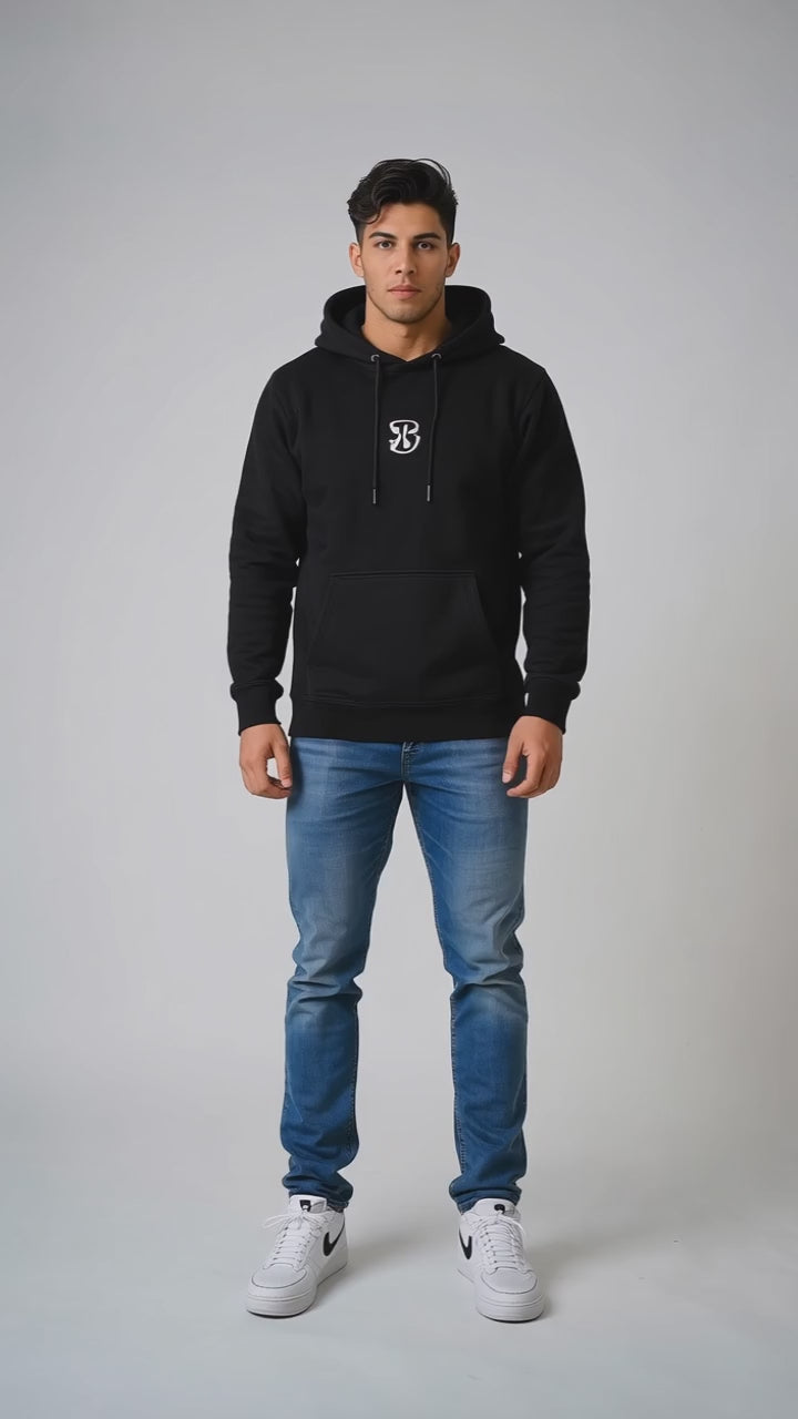 Model wearing the black DOMIN8NY Royal Flush fleece hoodie, front view