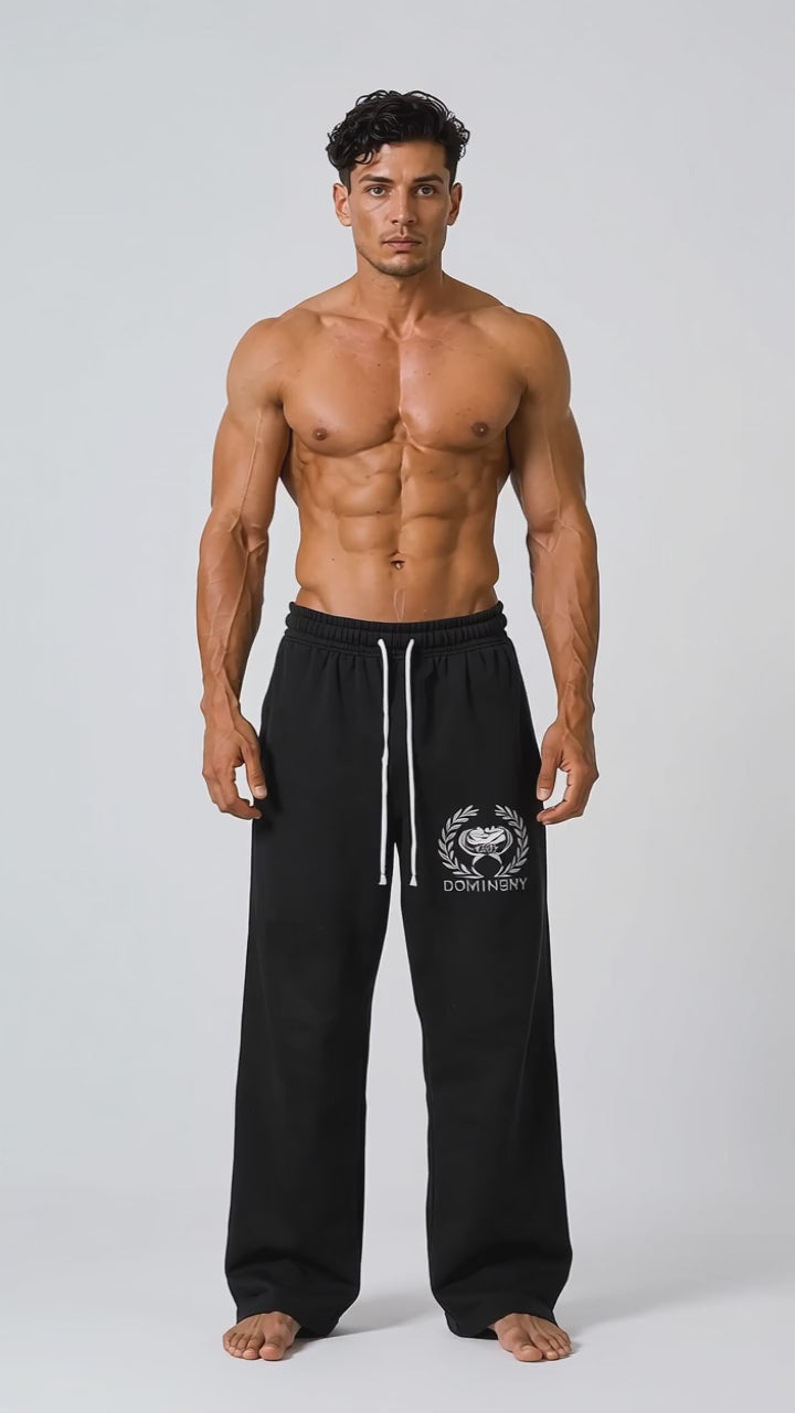 Model wearing the black DOMIN8NY Royal Flush straight-leg pants, front view