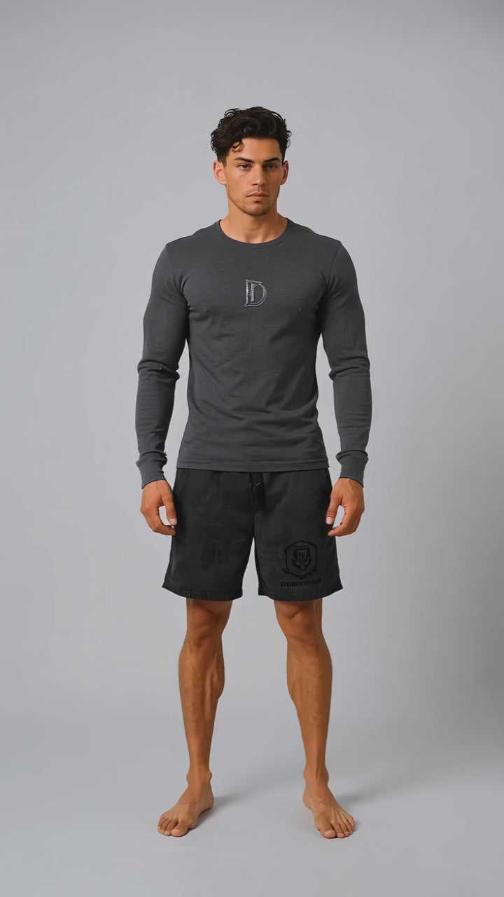 Model wearing the black DOMIN8NY Royal Flush long-sleeve T-shirt, front view
