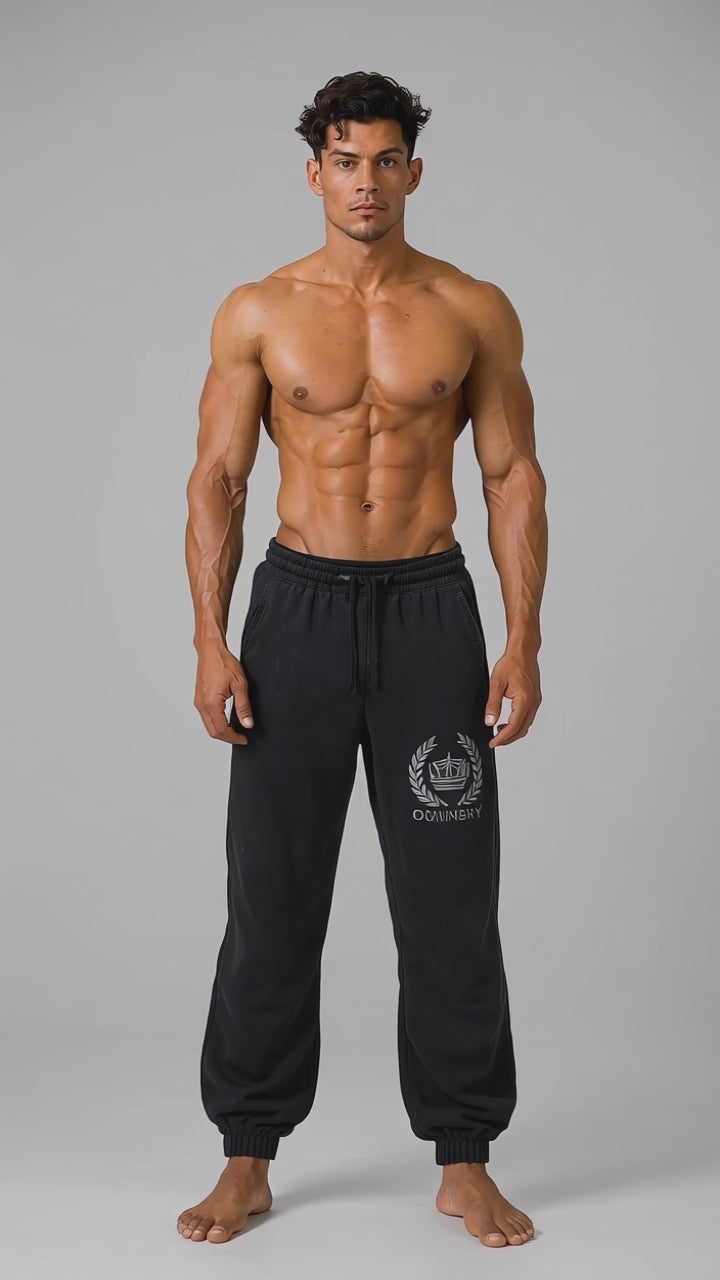 Model wearing the black DOMIN8NY Crown fleece sweatpants, front view