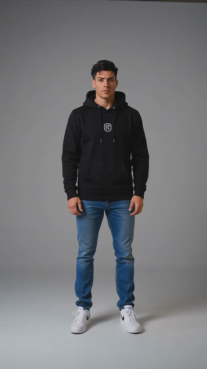 Model wearing the black DOMIN8NY Lion fleece hoodie, front view
