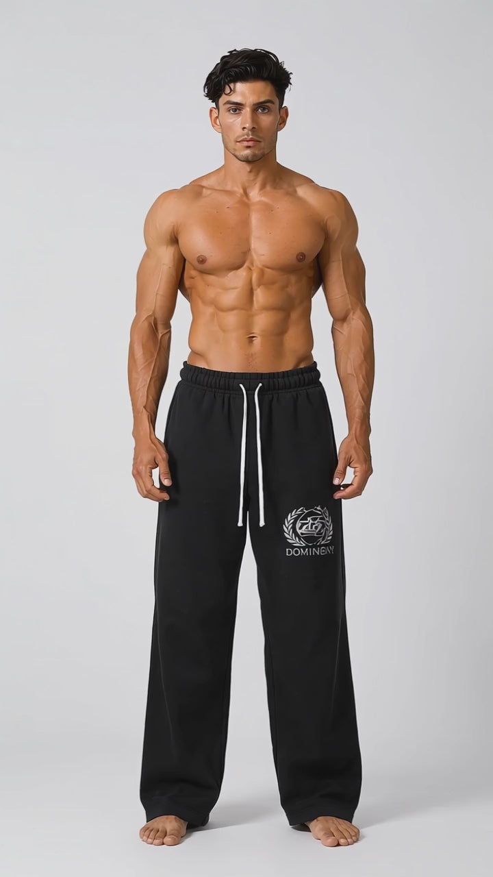 Model wearing the black DOMIN8NY Crown straight-leg pants, front view
