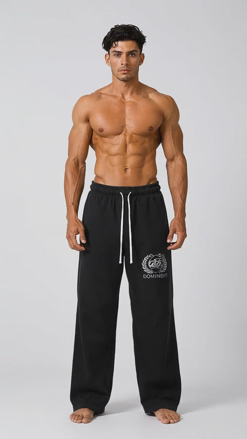 Model wearing the black DOMIN8NY Crown straight-leg pants, front view