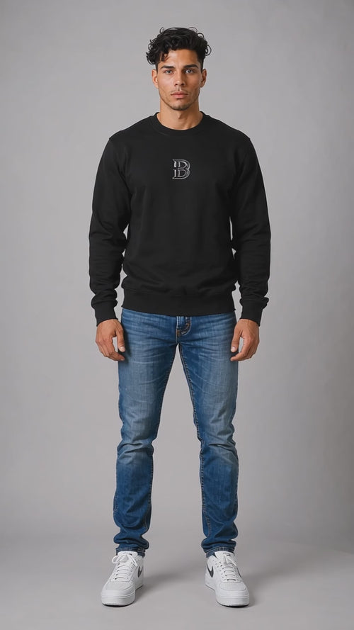 Model wearing the black DOMIN8NY Crown graphic sweatshirt, front view