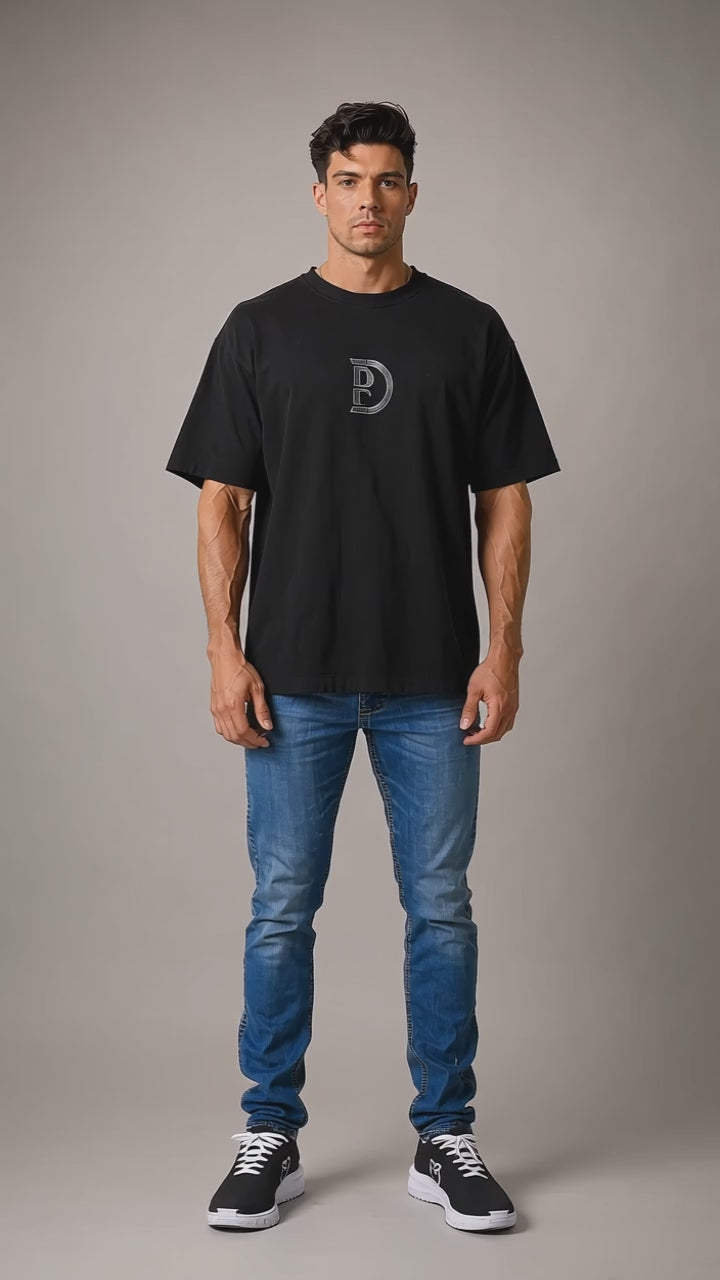 Model wearing the black DOMIN8NY Skull graphic T-shirt, front view