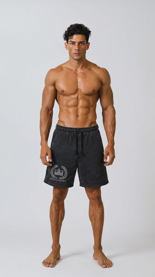 Model wearing the black DOMIN8NY Crown vintage-wash shorts, front view