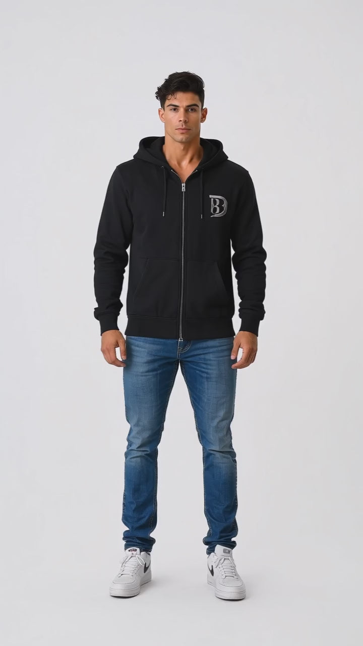 Model wearing the black DOMIN8NY Royal Flush zip-up hoodie, front view