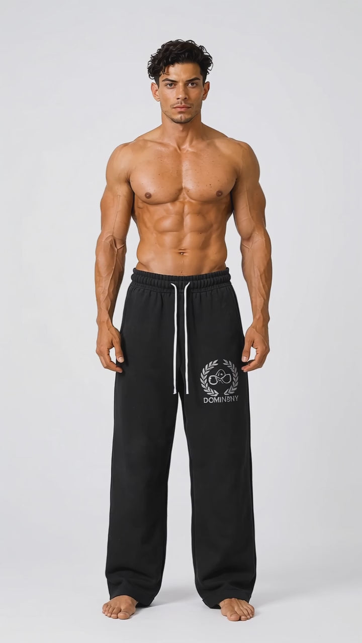Model wearing the black DOMIN8NY Dragon straight-leg pants, front view